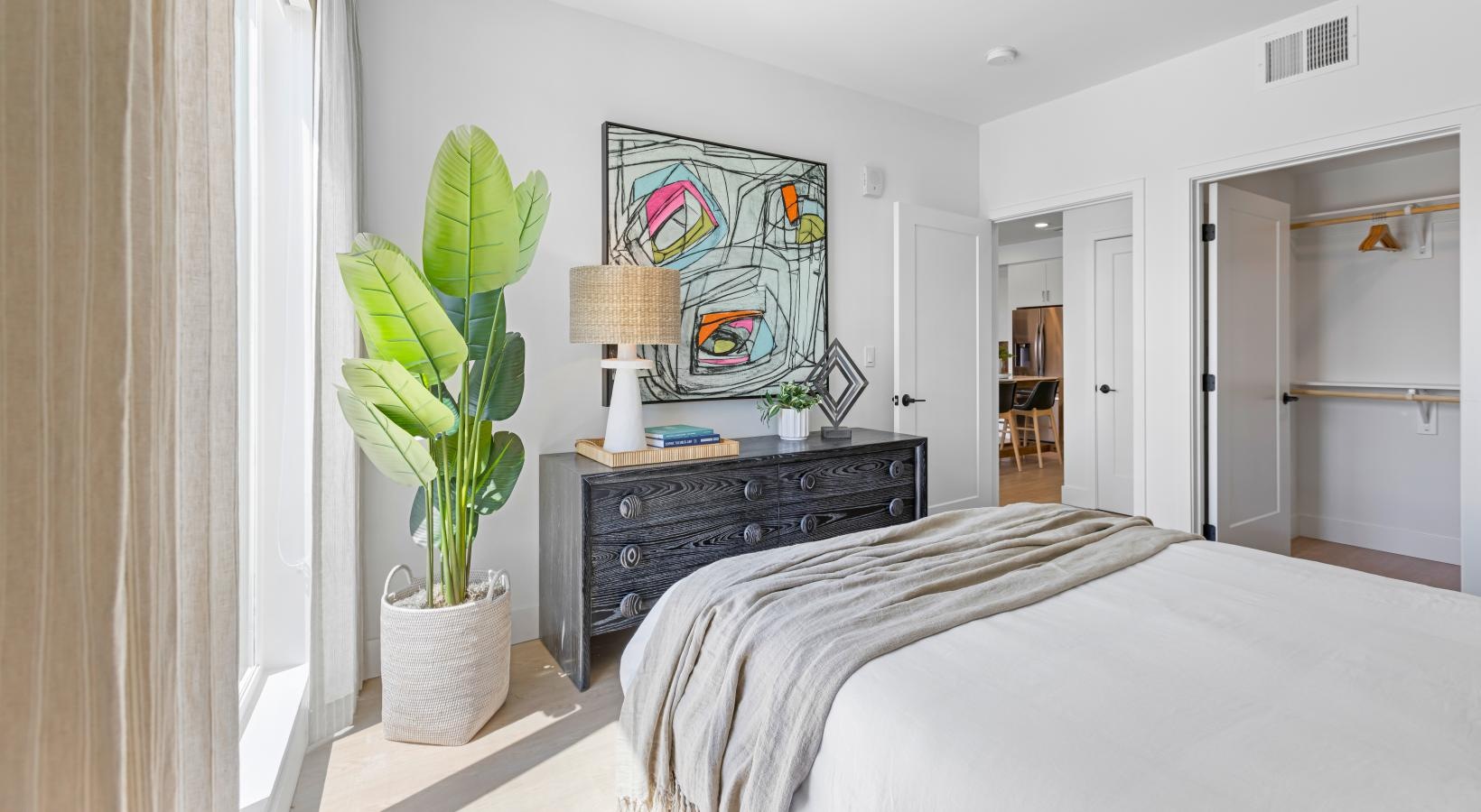 Beautiful bedrooms to fit every need a bedroom with a bed and a plant in a pot