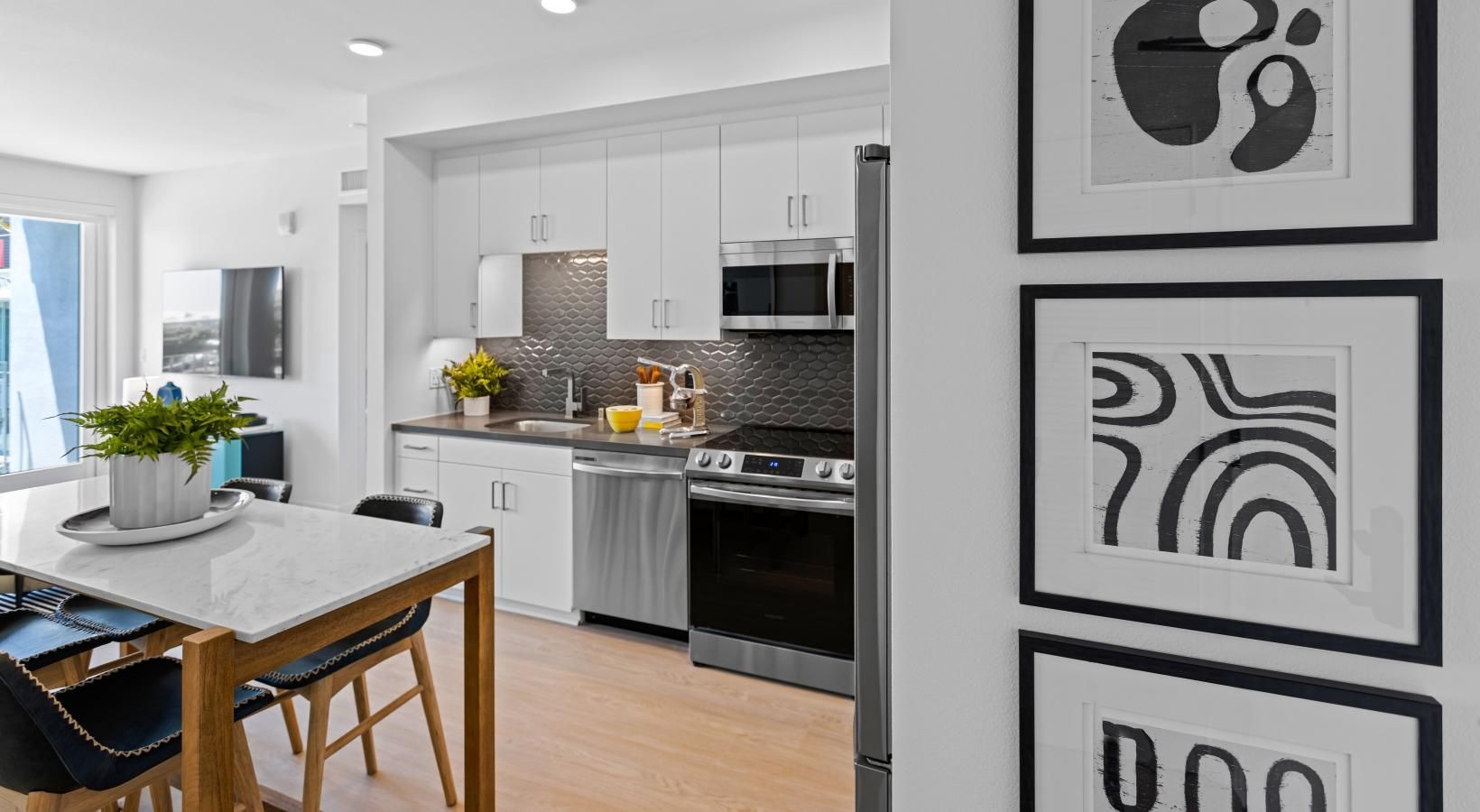 Spacious kitchens with thoughtful details a kitchen with a table and chairs