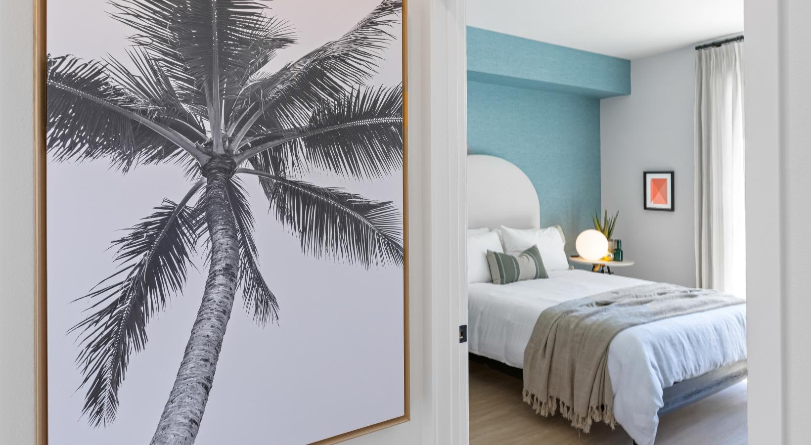 Relax and recharge in beautiful and spacious bedrooms a bedroom with a painting on the wall