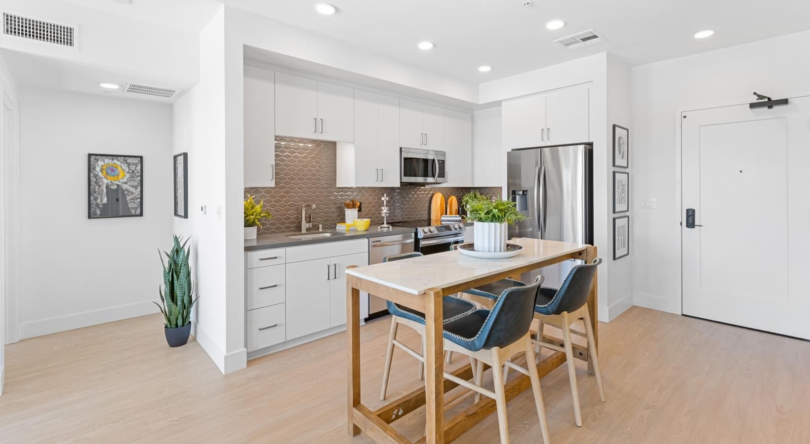 Spacious kitchens with thoughtful details a kitchen with white cabinets