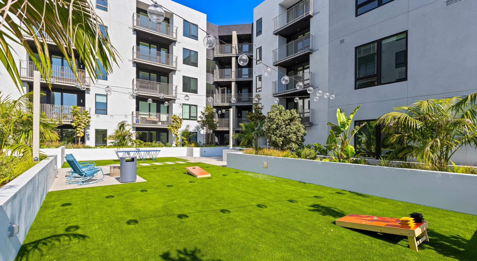 Everything within reach a lawn with chairs and a table