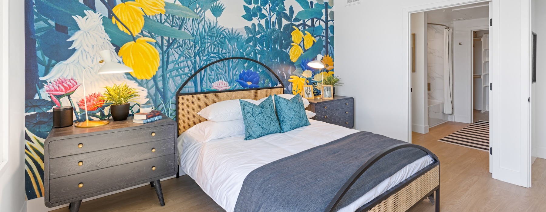 a bedroom with a painting on the wall