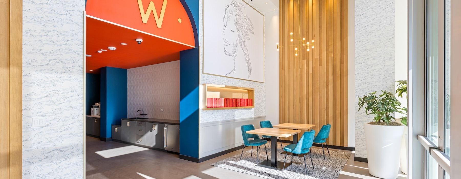 a room with a table chairs and a sign on the wall