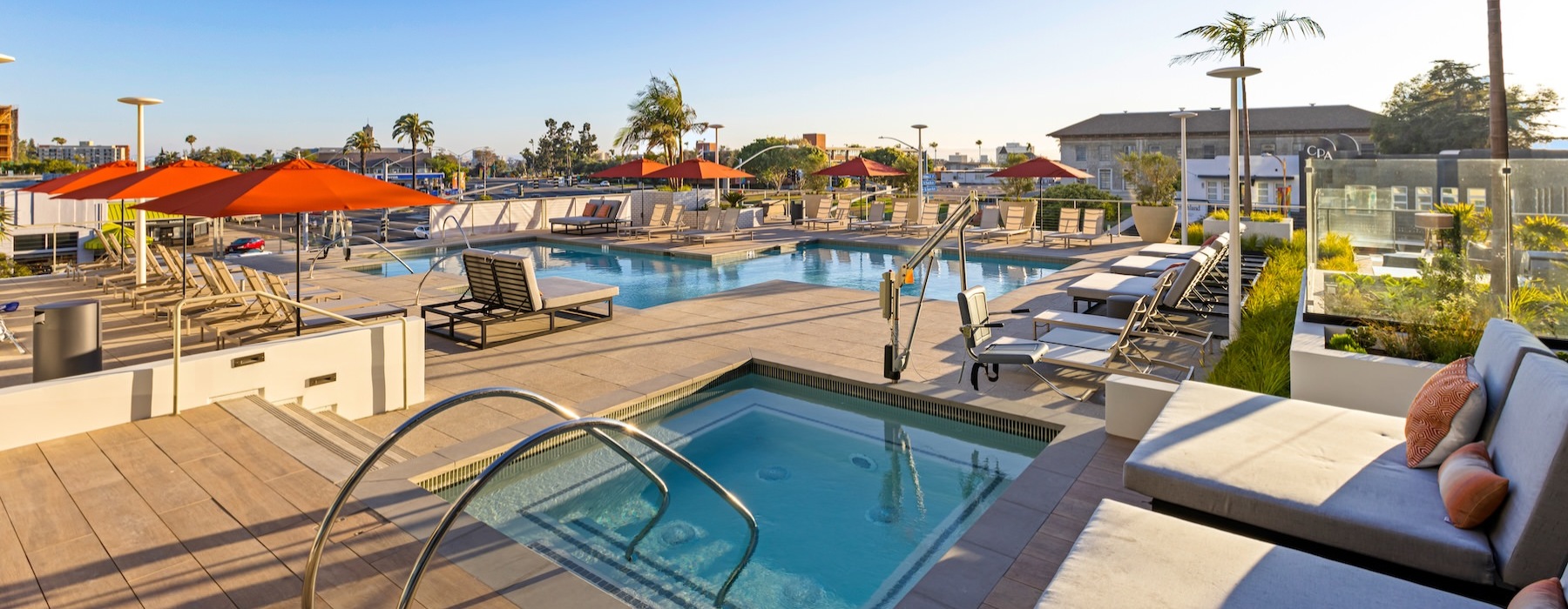 two swimming pools in an outdoor lounge area