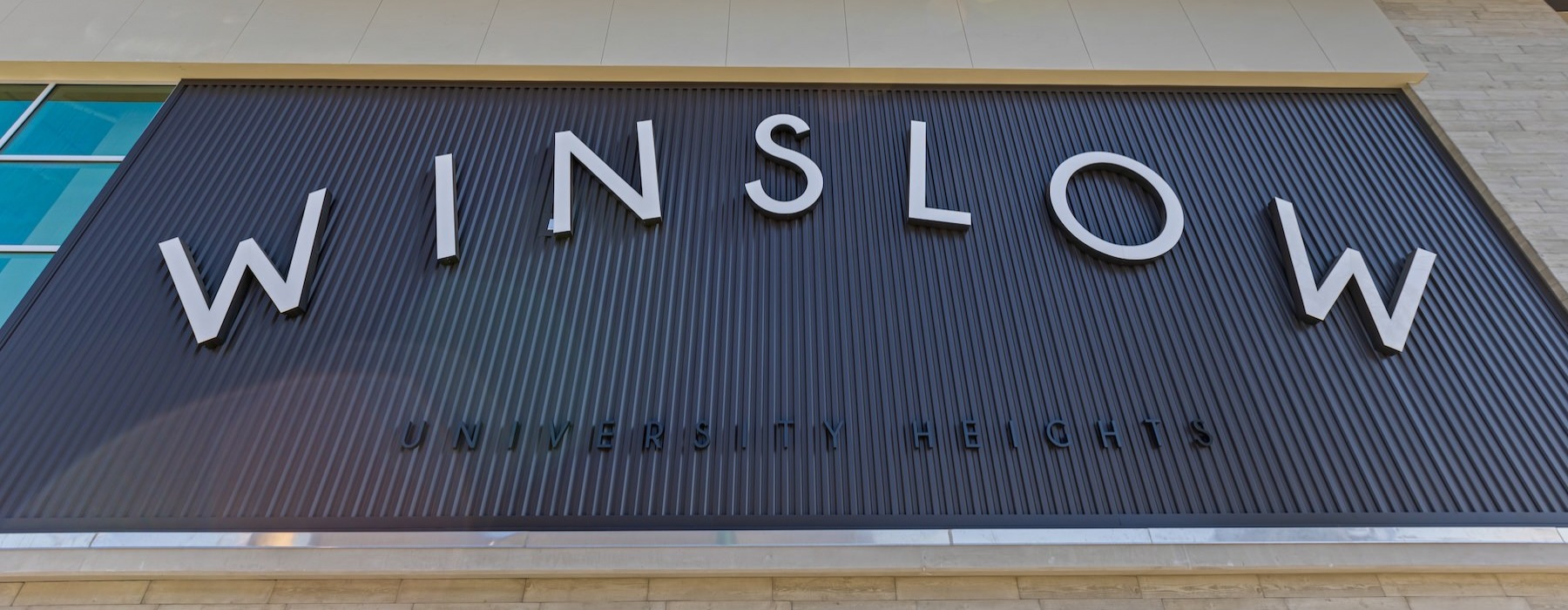 Settle into comfort at Winslow a sign on a building