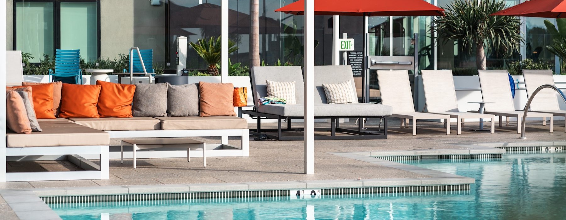 a pool with chairs and umbrellas