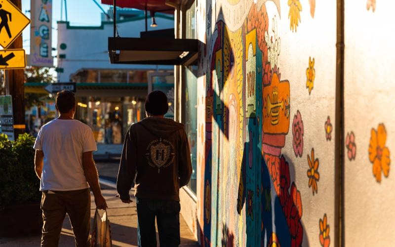 people walking down a sidewalk