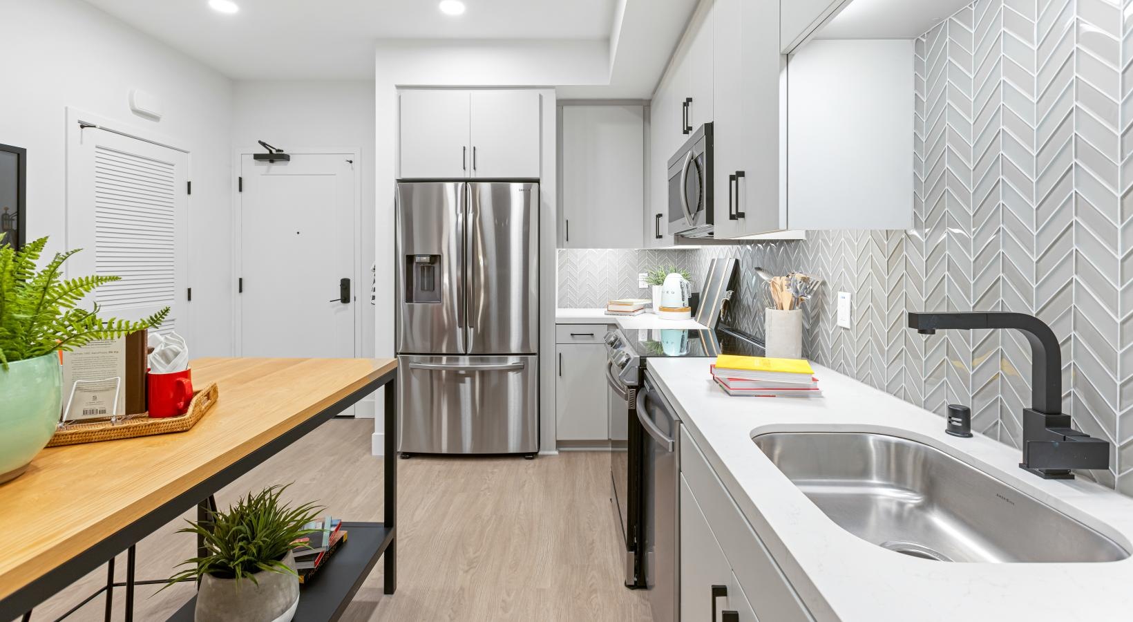 Spacious living areas to recline and recharge a kitchen with white cabinets