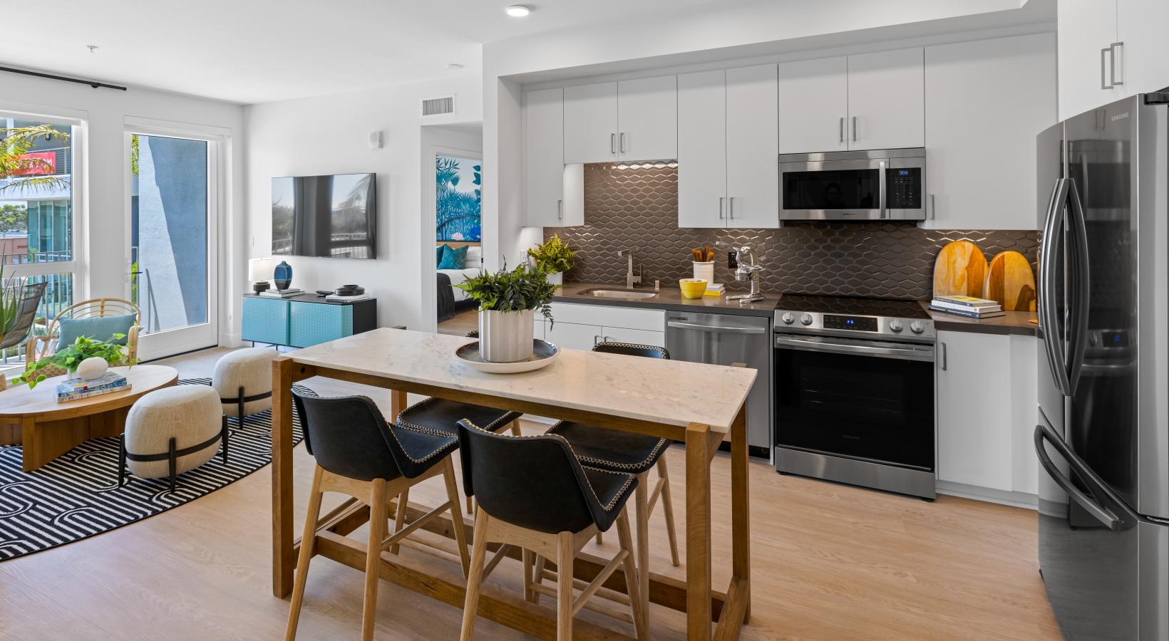 Spacious kitchens with thoughtful details a kitchen with a table and chairs