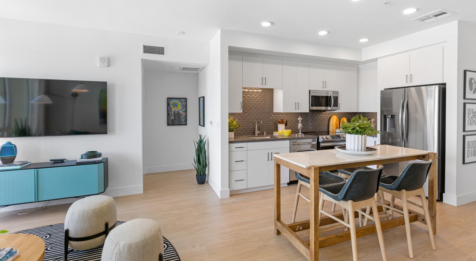 Beautiful kitchens with designer finishes a kitchen with a dining table and chairs