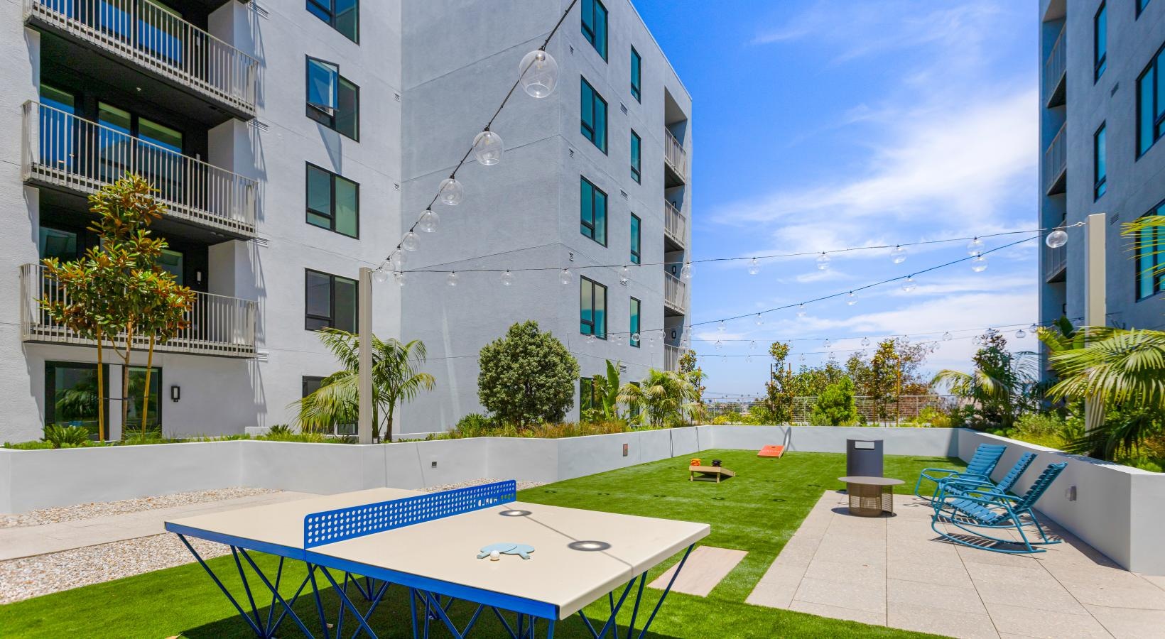 Access to resident-only features a courtyard with a table and chairs