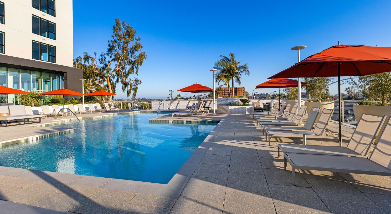 Resort-style swimming pool a pool with lounge chairs around it